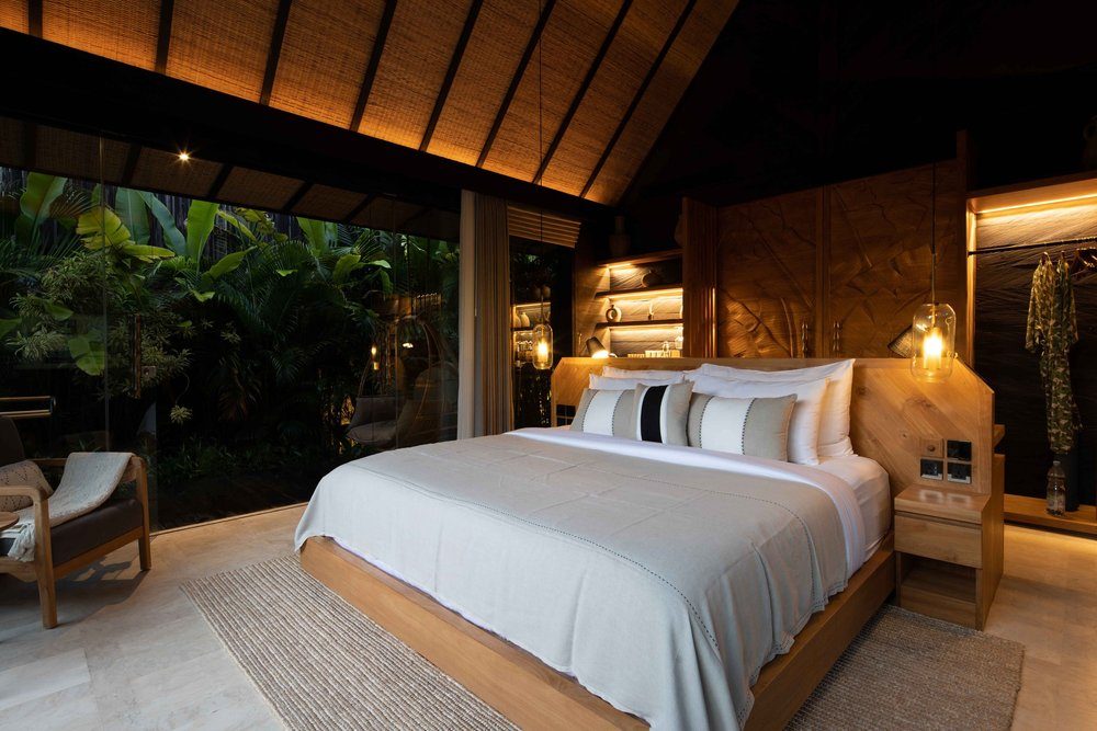 Villa interior with king size bed and floor-to-ceiling windows